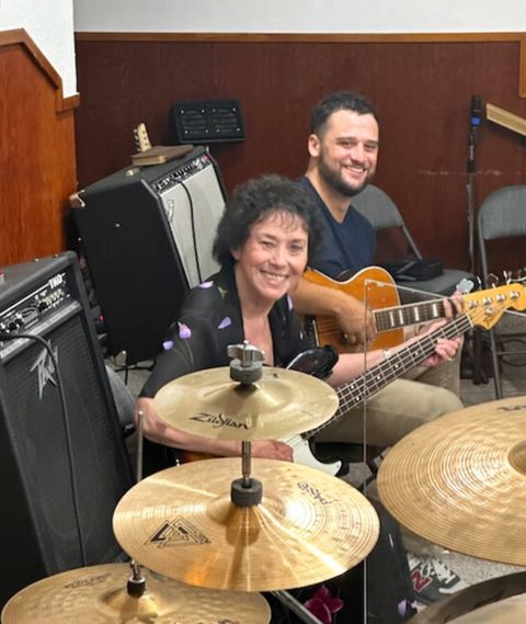 Pastor Joyce at the drums with a guitarist beside her during worship