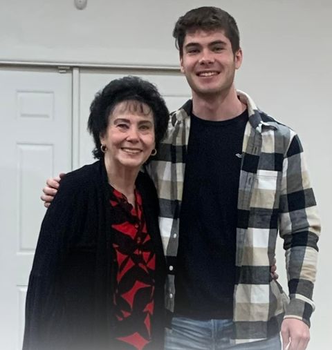 Pastor Joyce with her arm around her grandson